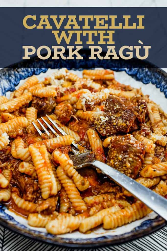 A bowl of cavatelli pasta with pork rag&ugrave; with a fork
