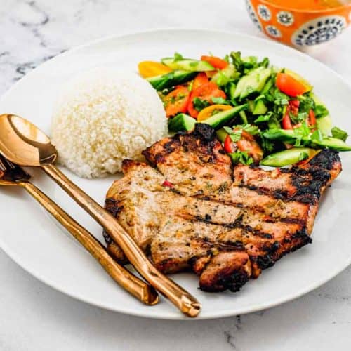 Pork chops marinated in lemongrass and other aromatic Vietnamese ingredients. Served with a simple salad of cucumber, tomato and herbs. A Nước chấm dipping sauce accompanies.
