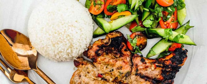 Pork chops marinated in lemongrass and other aromatic Vietnamese ingredients. Served with a simple salad of cucumber, tomato and herbs. A Nước chấm dipping sauce accompanies.