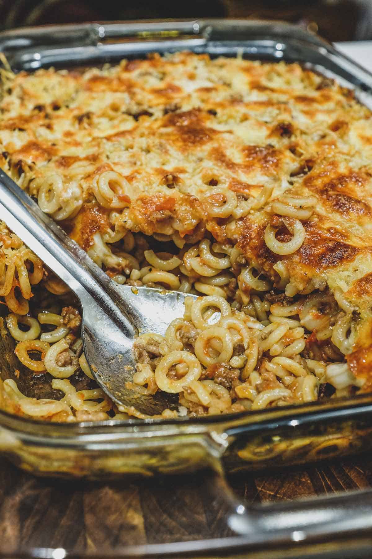 Anelletti Al Forno - baked rings of pasta in a tomato sauce with a serving spoon