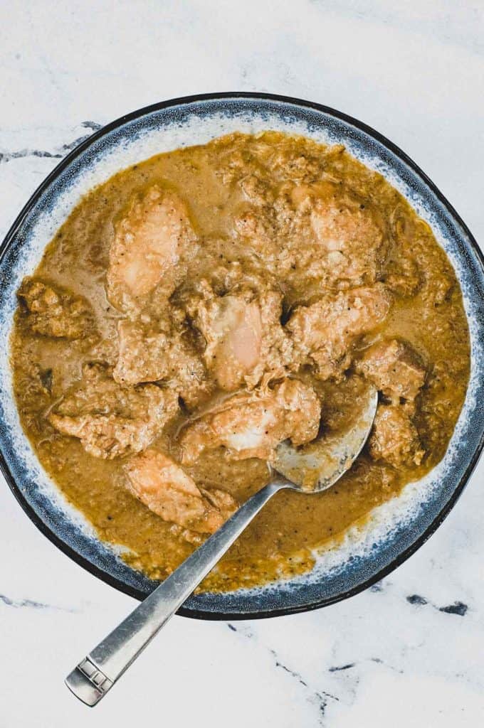 A bowl of Chicken Korma Curry with a spoon