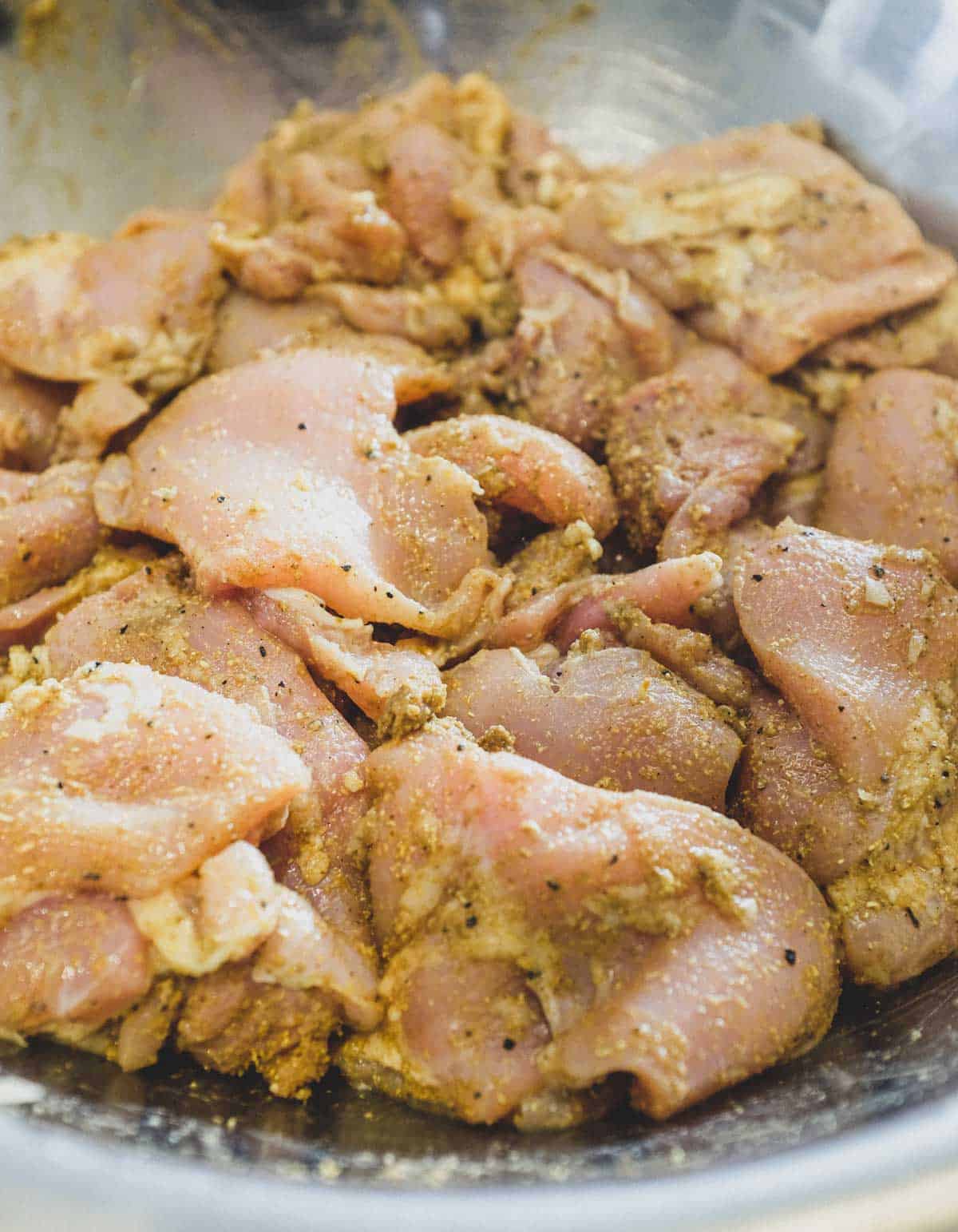 Chicken marinating in a large bowl for Middle Eastern Kebabs