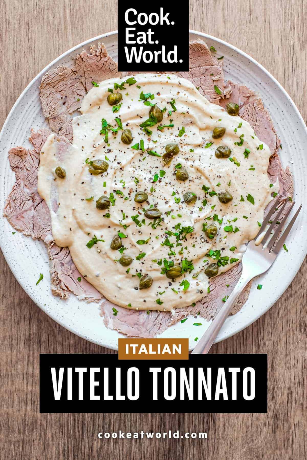 A large platter of Italian Vitello Tonnato (veal slices with a tuna mayonnaise) garnished with parsley and capers.
