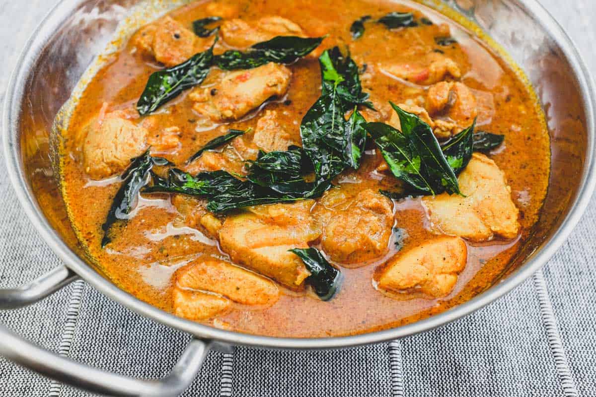 Achari Chicken in a silver serving bowl