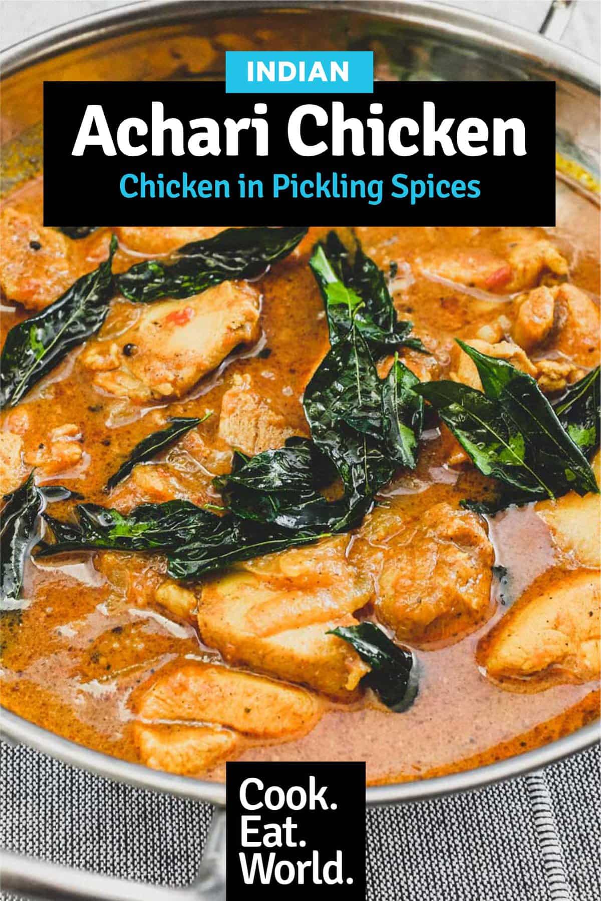 Achari Chicken in a silver bowl scattered with fried curry leaves