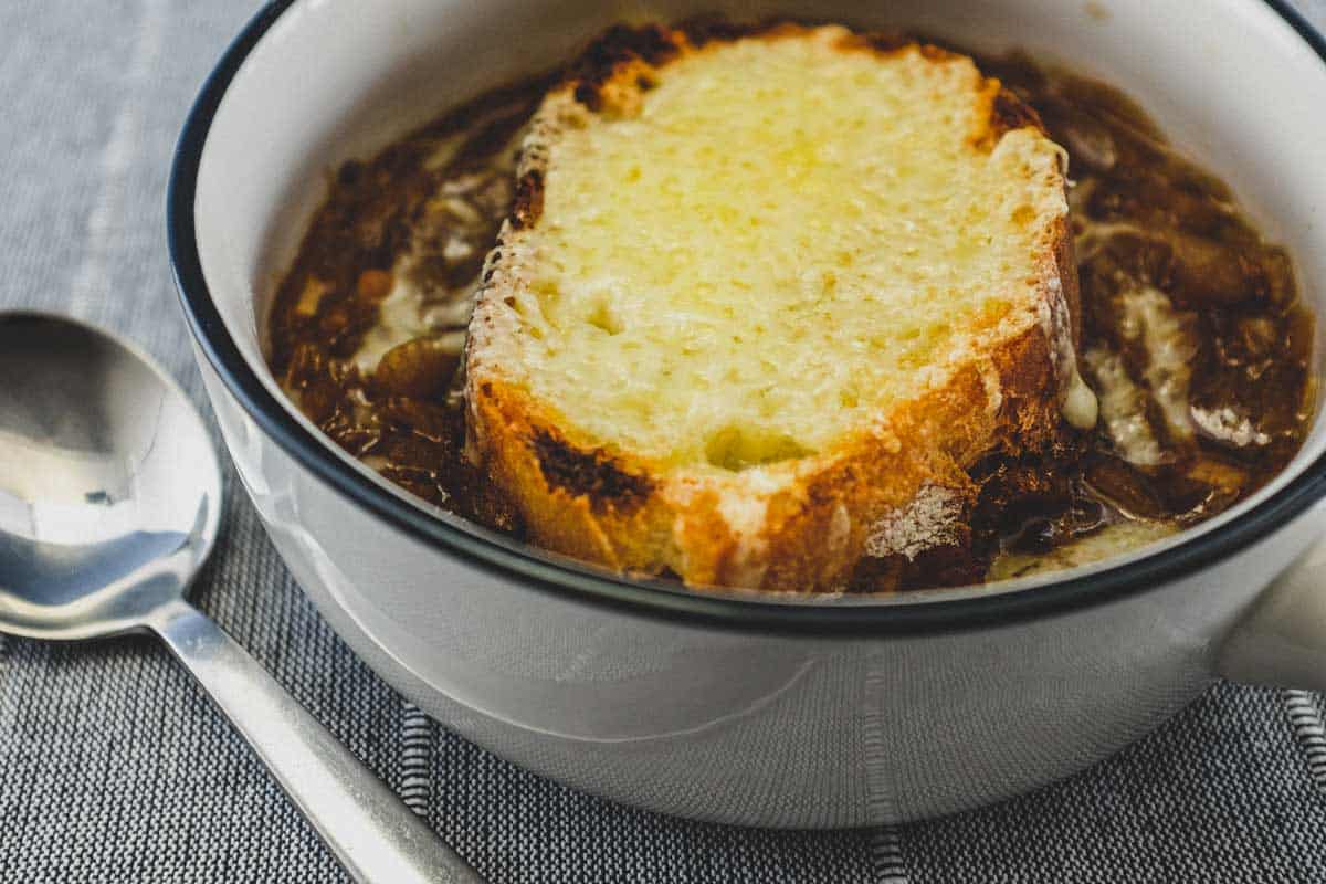 A small bowl of French Onion Soup with Gruyere Crouton