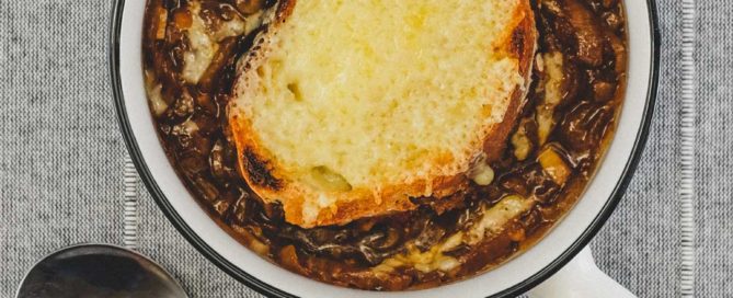 A small bowl of French Onion Soup with Gruyere Crouton