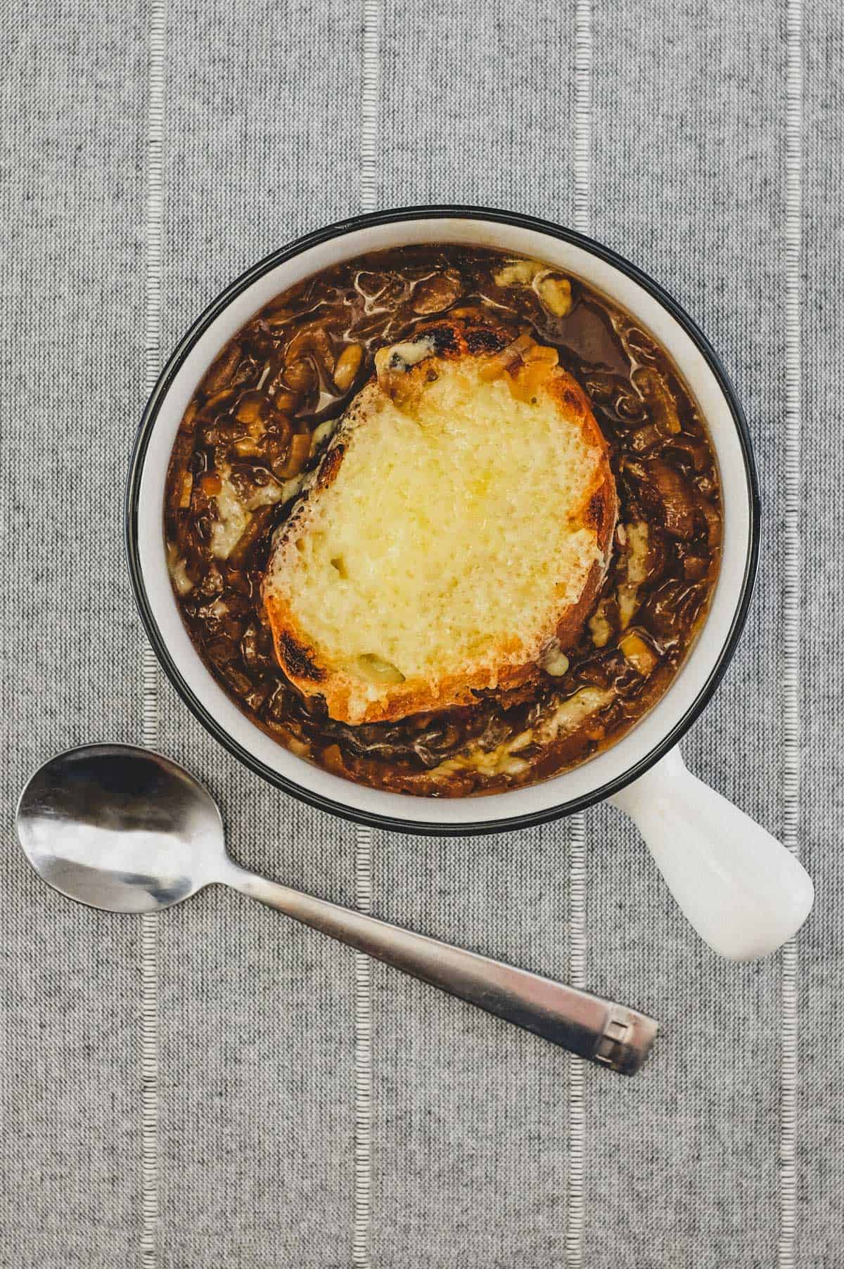 A small bowl of French Onion Soup with Gruyere Crouton