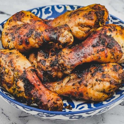 A bowl of cha-style chicken grilled over hot coals. Thai-Style Grilled Chicken (Gai Yang)