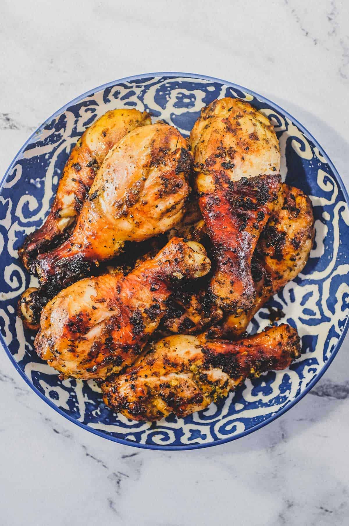 A bowl of cha-style chicken grilled over hot coals. Thai-Style Grilled Chicken (Gai Yang)