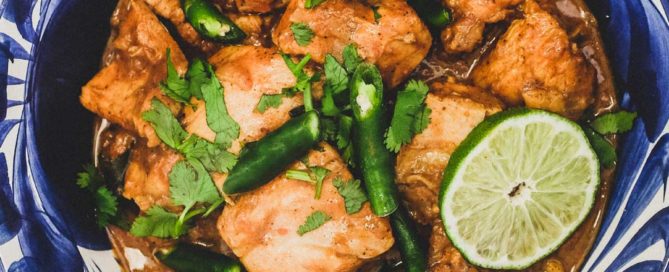A blue bowl containing Keralan Chicken Curry (Nadan Khozi)