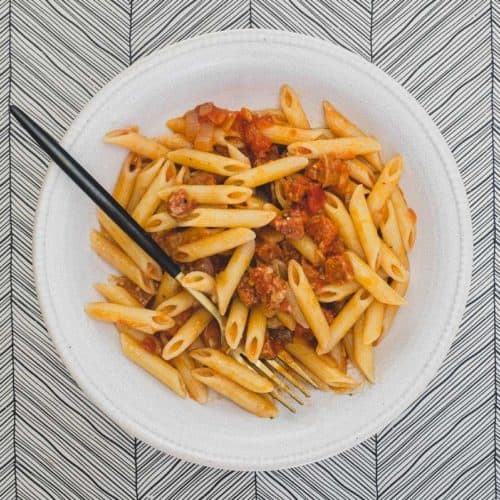 A bowl of pasta penne with salami