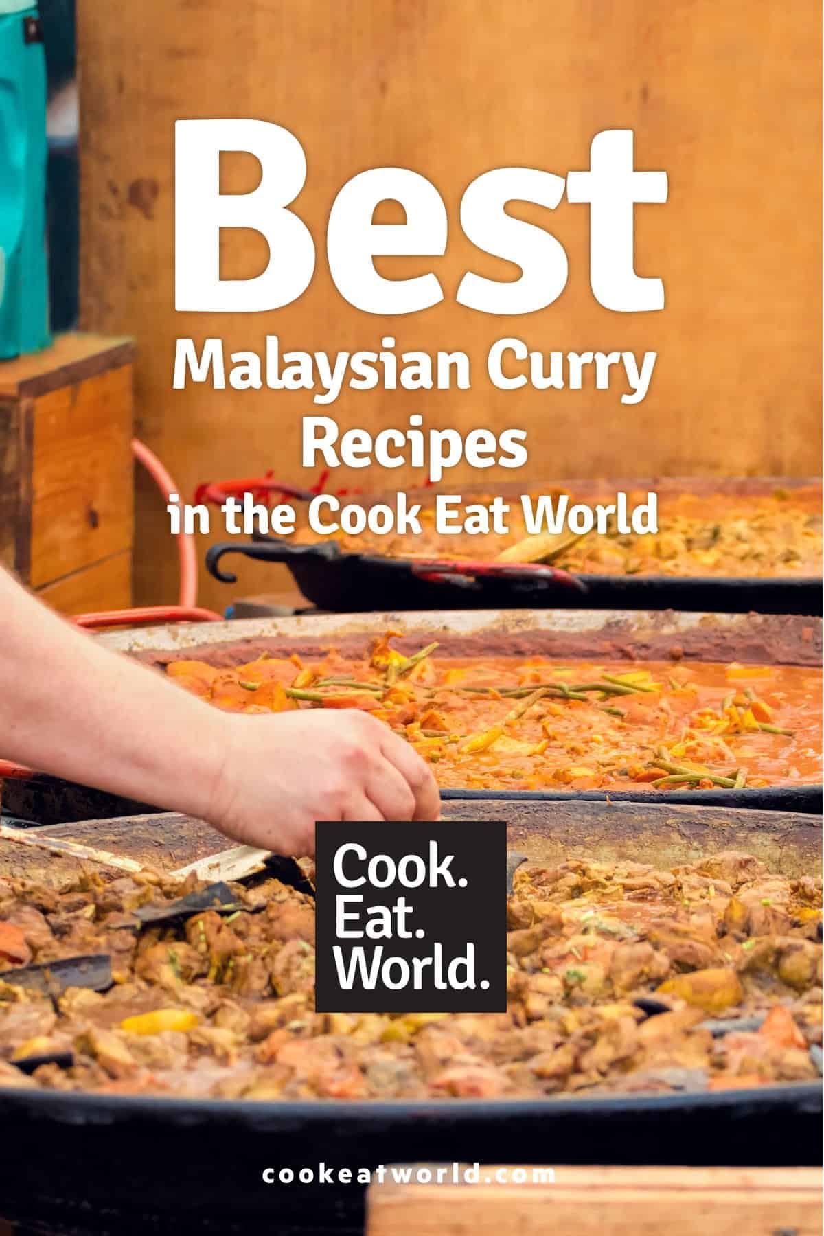 A man picks from a variety of Malaysian street food curries