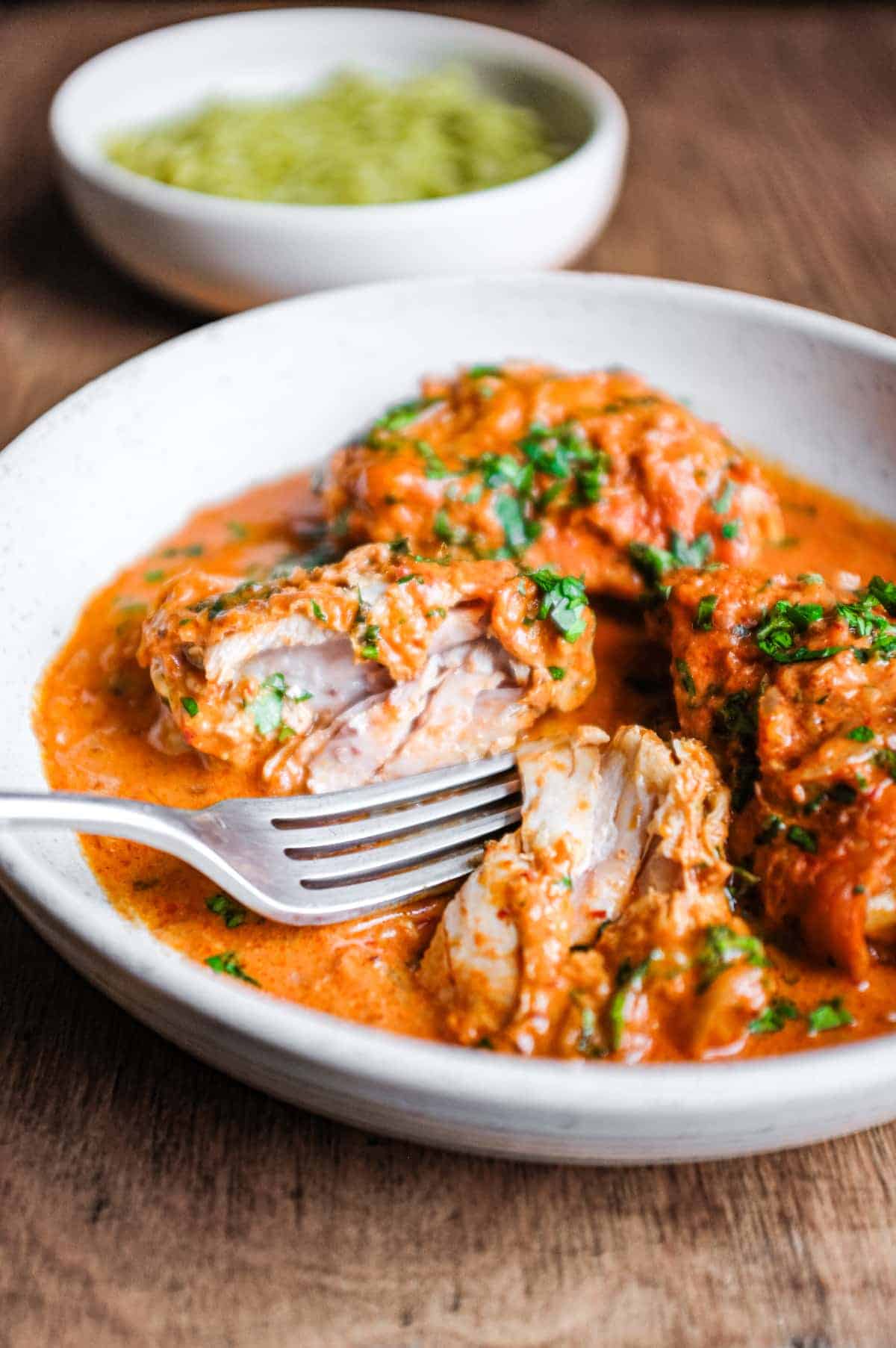 A bowl of Mexican chipotle chicken with a fork