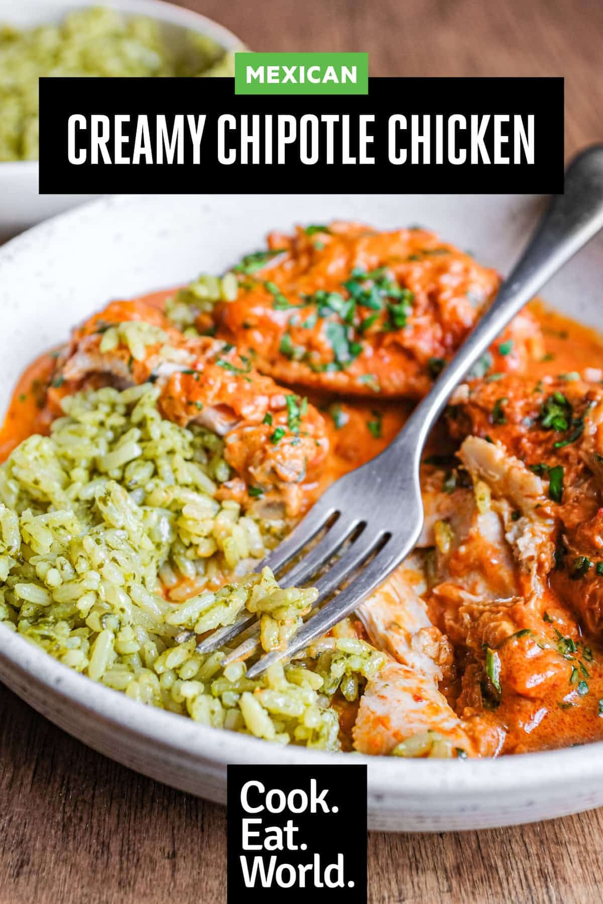 A bowl of Mexican chipotle chicken with green rice with a fork