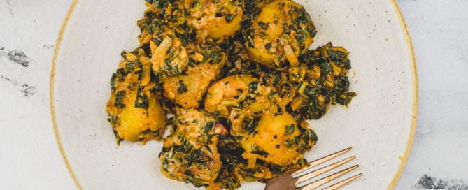 Saag aloo with tender potatoes in a spiced spinach sauce