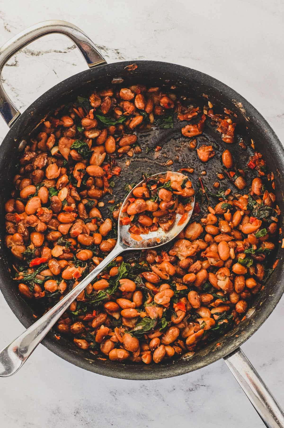 Borlotti beans cooked with chard (silverbeet) served from a pan