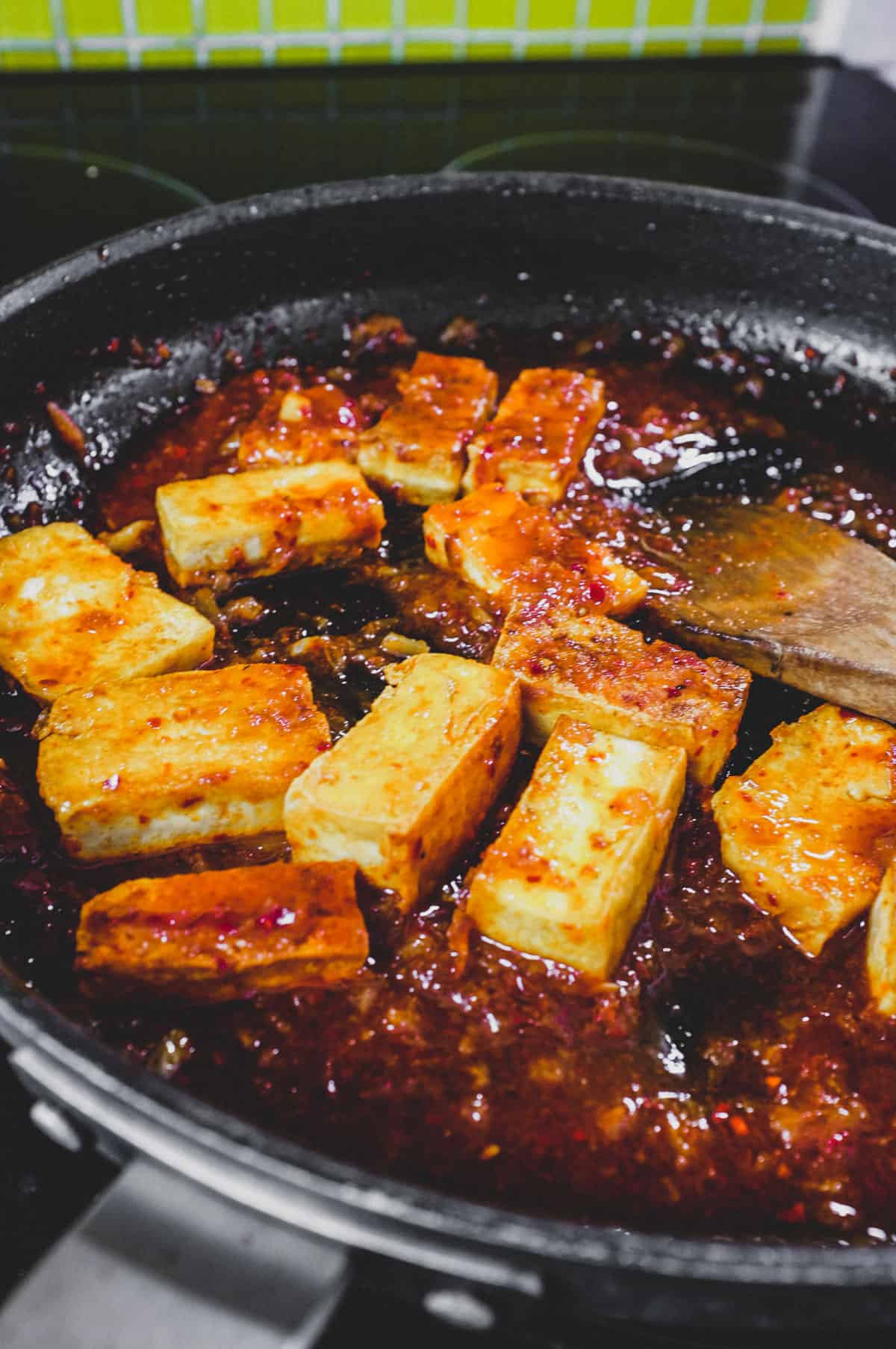 Fried tofu is lightly braised in Korean chilli (gochugaru)