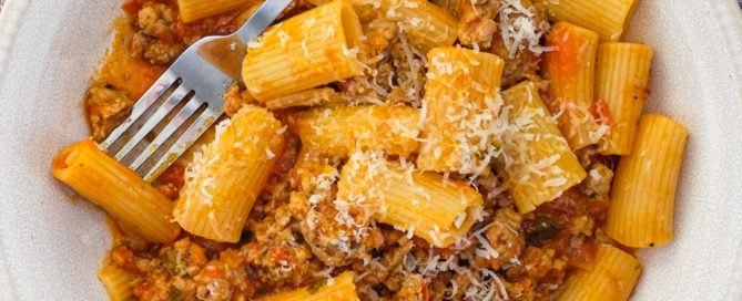 Rigatoni pasta in a bowl with sausage cooked in tomato sauce