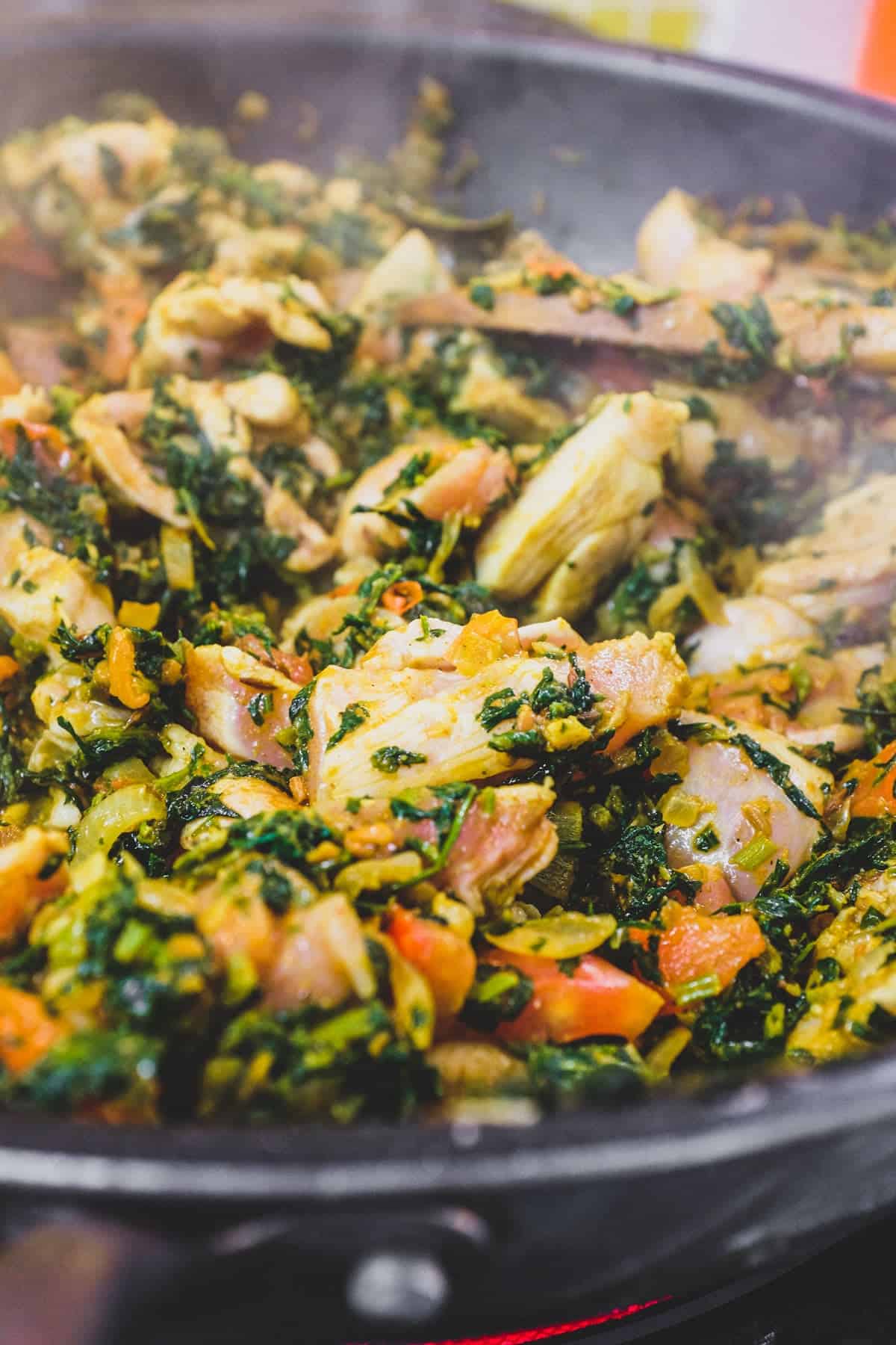 A pan with chicken curry made with fenugreek leaves