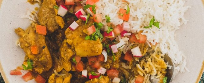 a plate of Indian Black Pepper Chicken Curry with rice