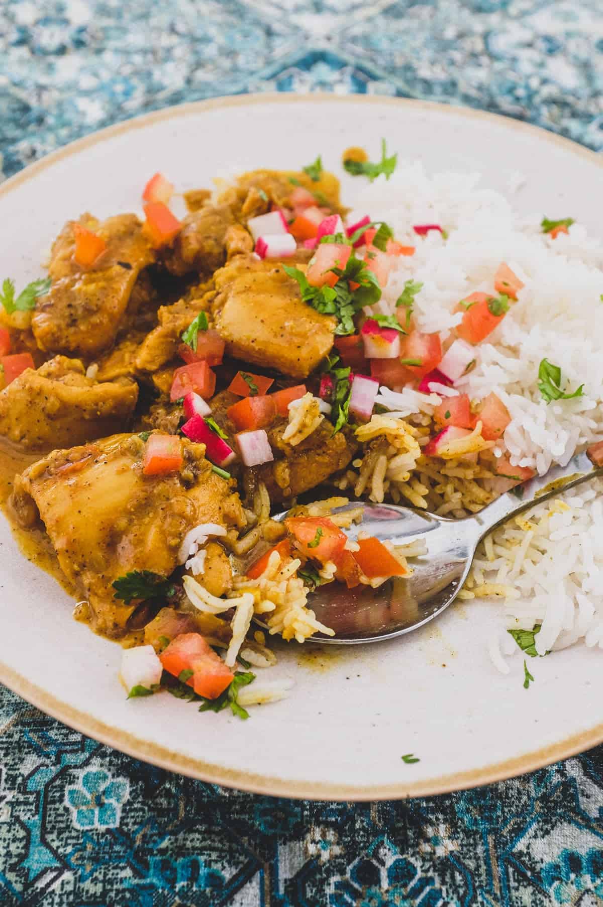 a plate of Indian Black Pepper Chicken Curry with rice