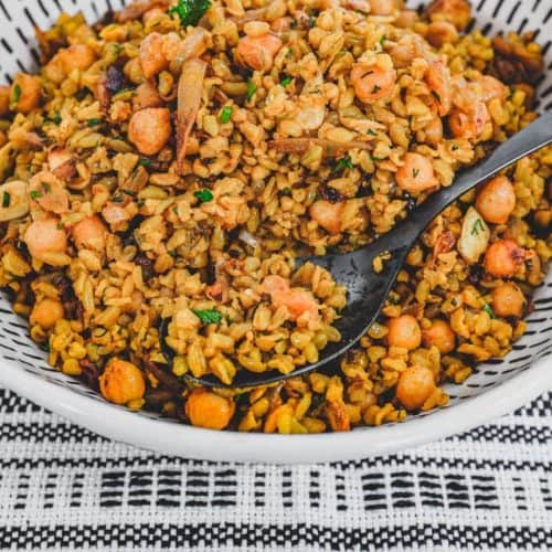 Freekeh cooked with onion and chickpeas in a large serving bowl