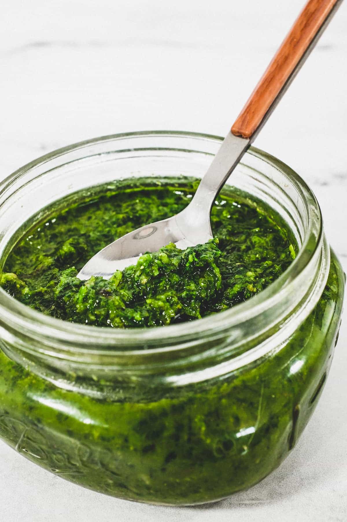 A small mason jar holds a green salsa from Georgia called Ajika