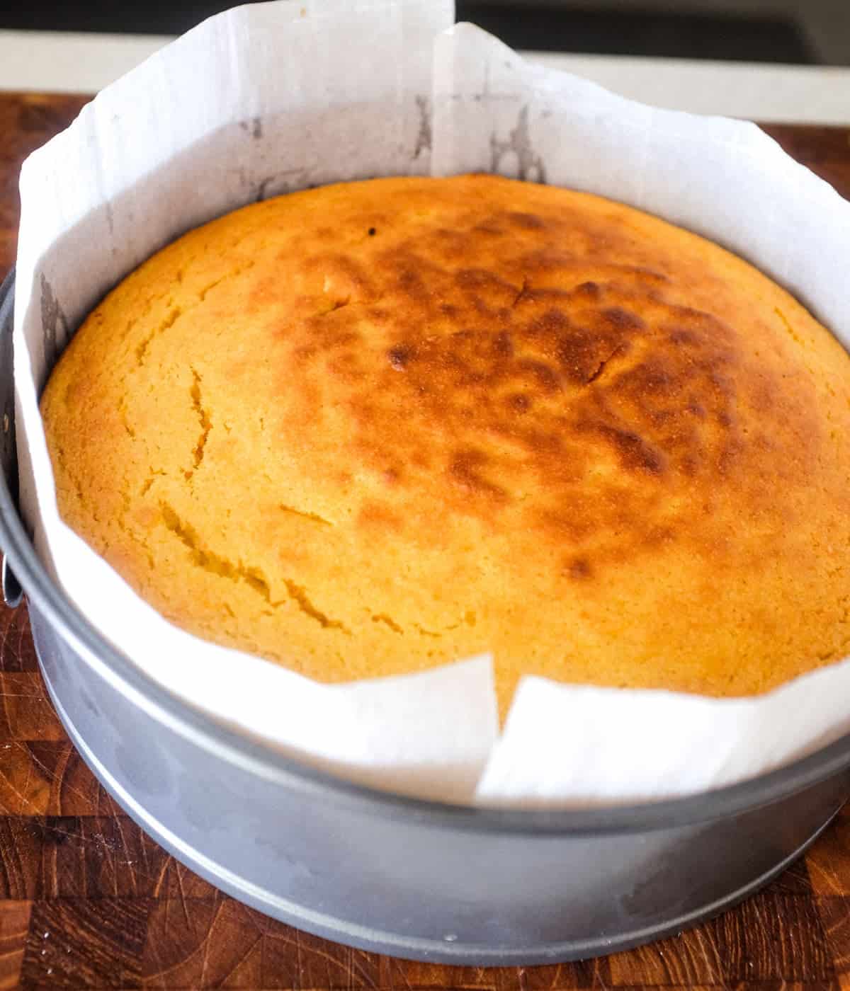 Flourless Orange Cake, fresh from the oven, with a lightly browned top.