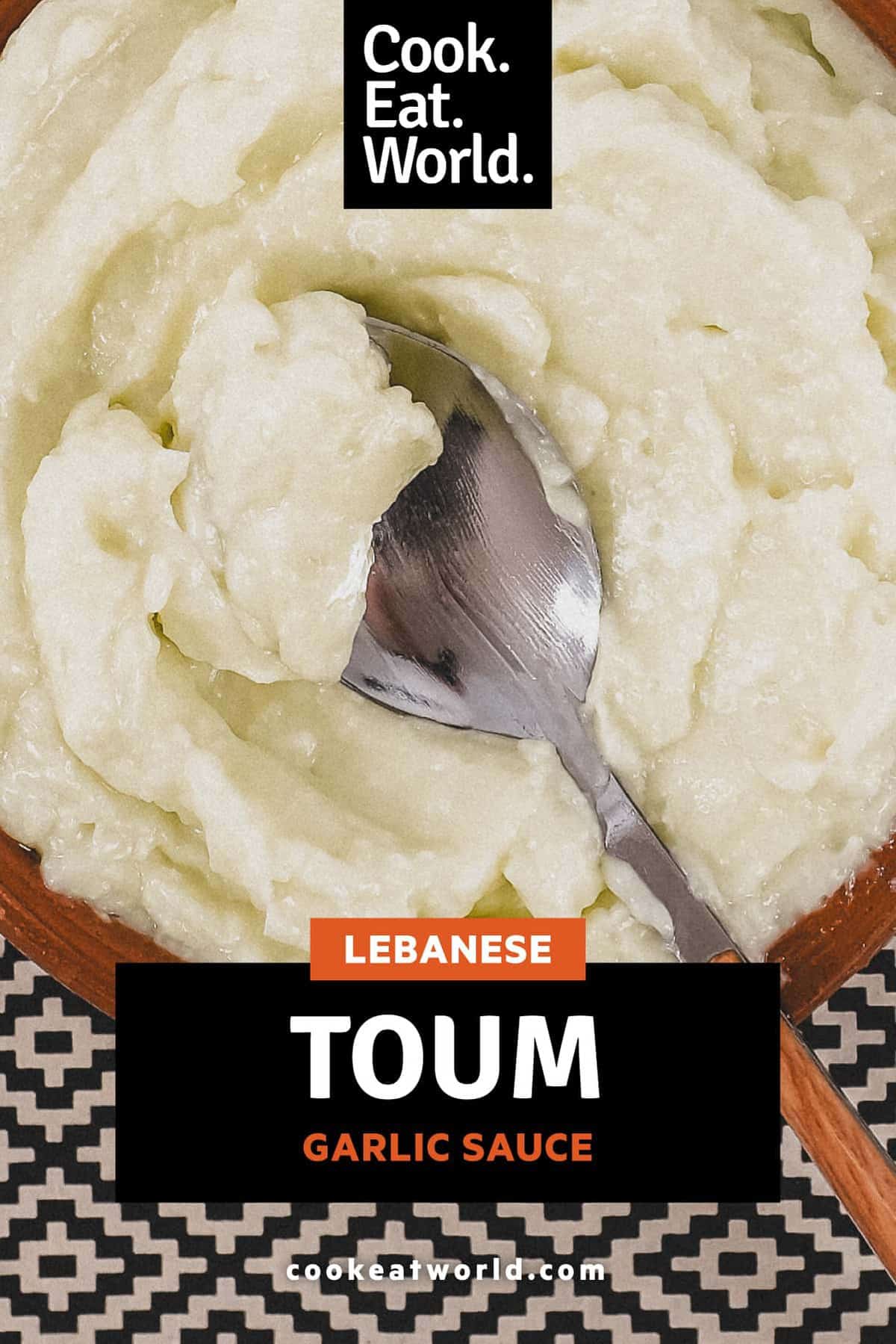 A small bowl of Lebanese garlic sauce, Toum with a spoon