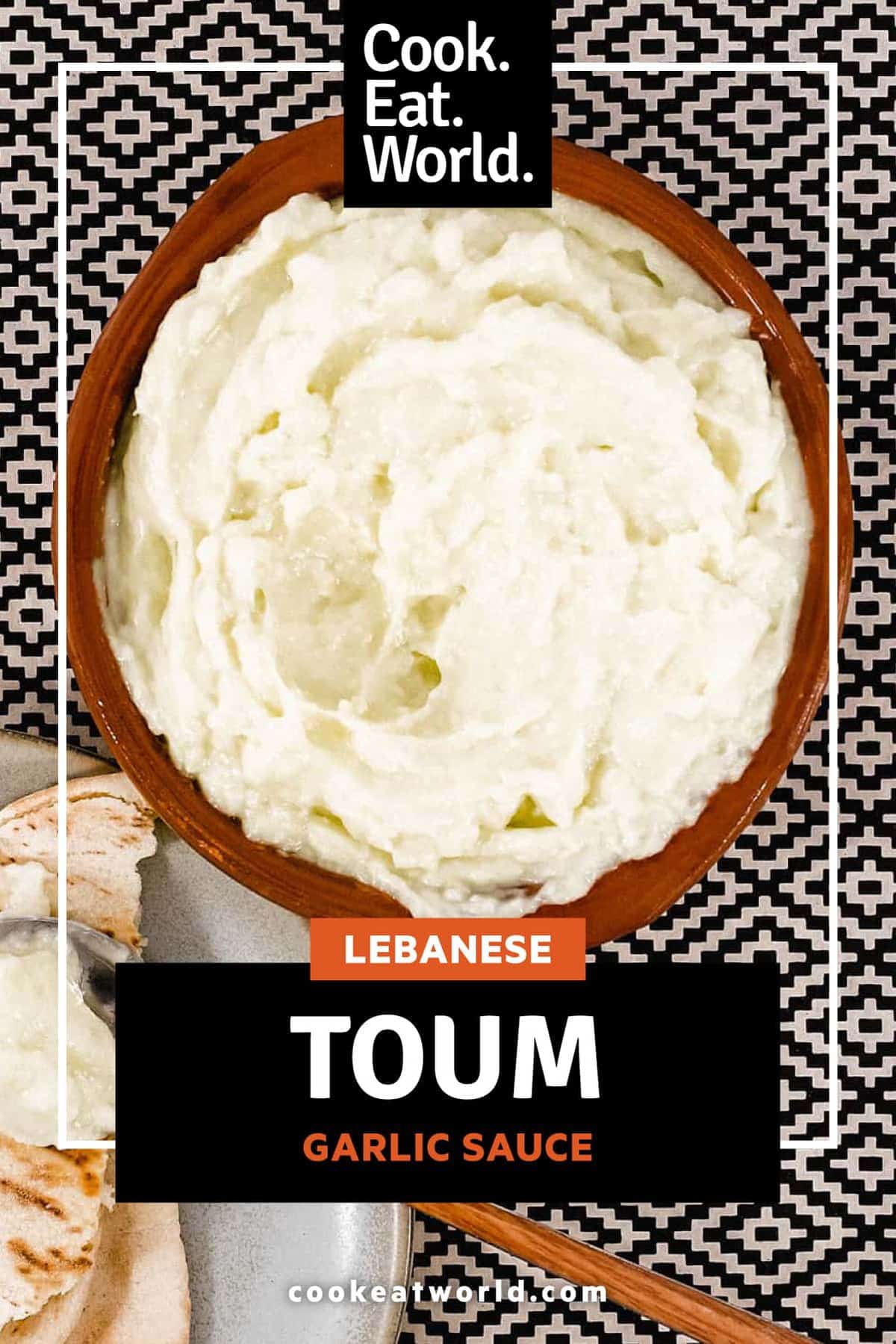 A small bowl of Lebanese garlic sauce, Toum with a spoon