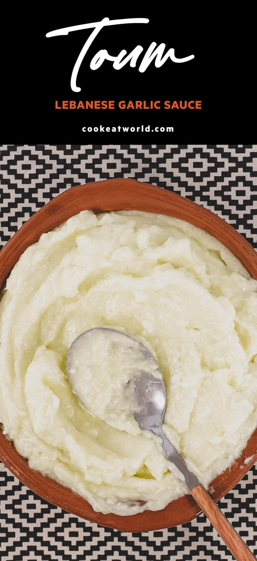 A small bowl of Lebanese garlic sauce, Toum with a spoon