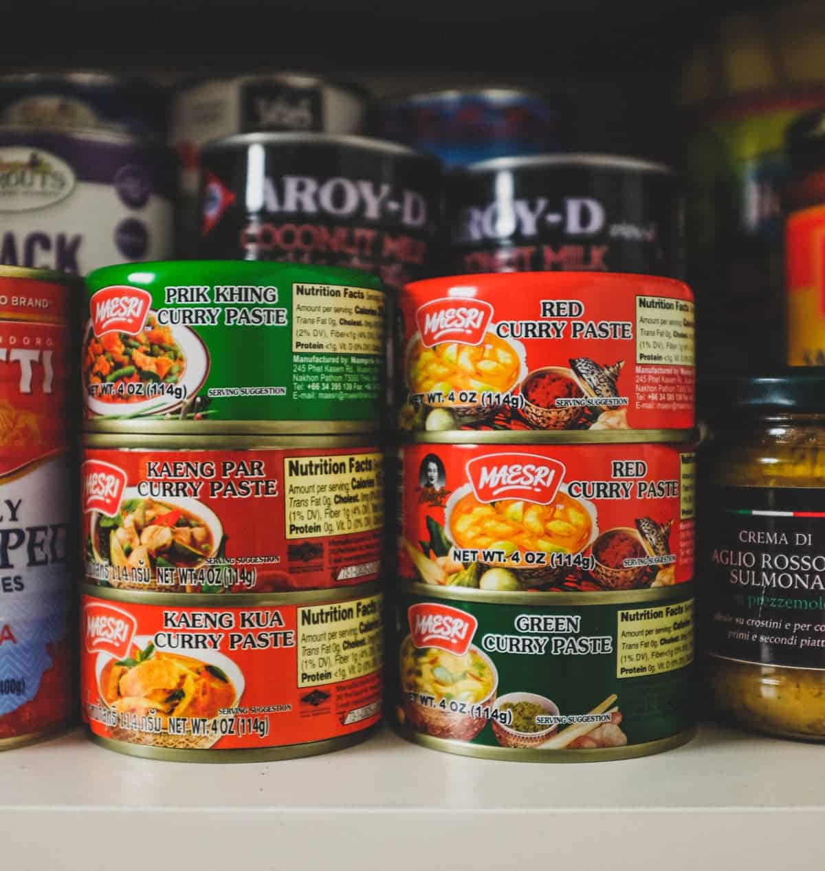 A selection of Thai curry pastes in a store cupboard. Including a paste for Prik Khing