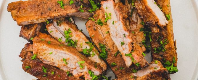 Pork ribs sit on a large platter.