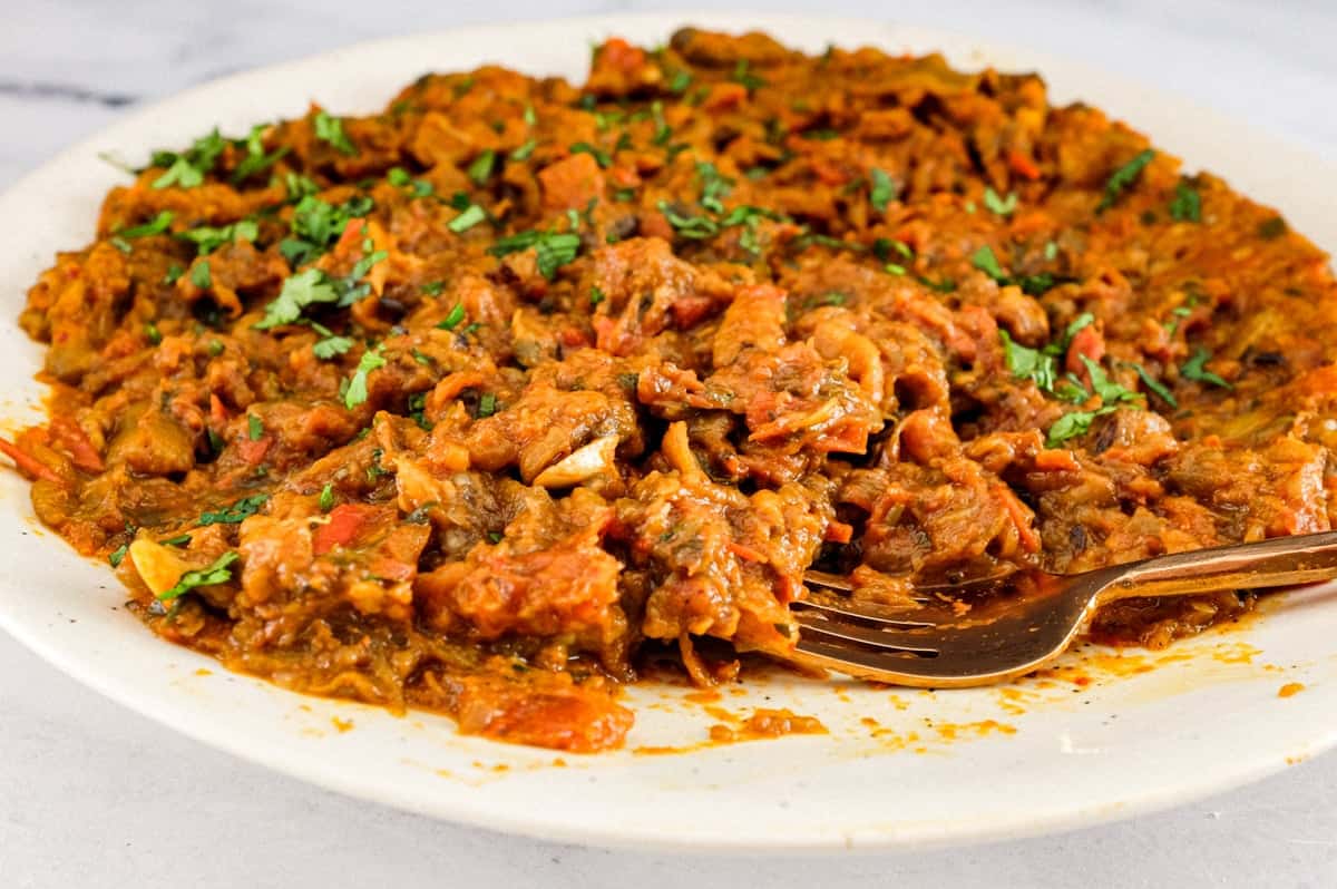 Zaalouk, a Moroccan dip or salad on a platter with a fork