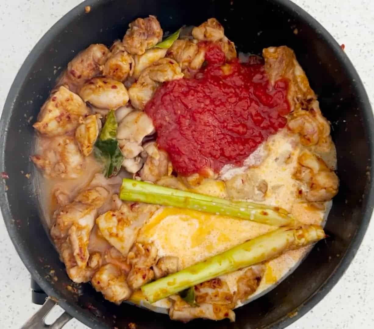 How to make Ayam Masak Merah - add the tomato, coconut milk and water