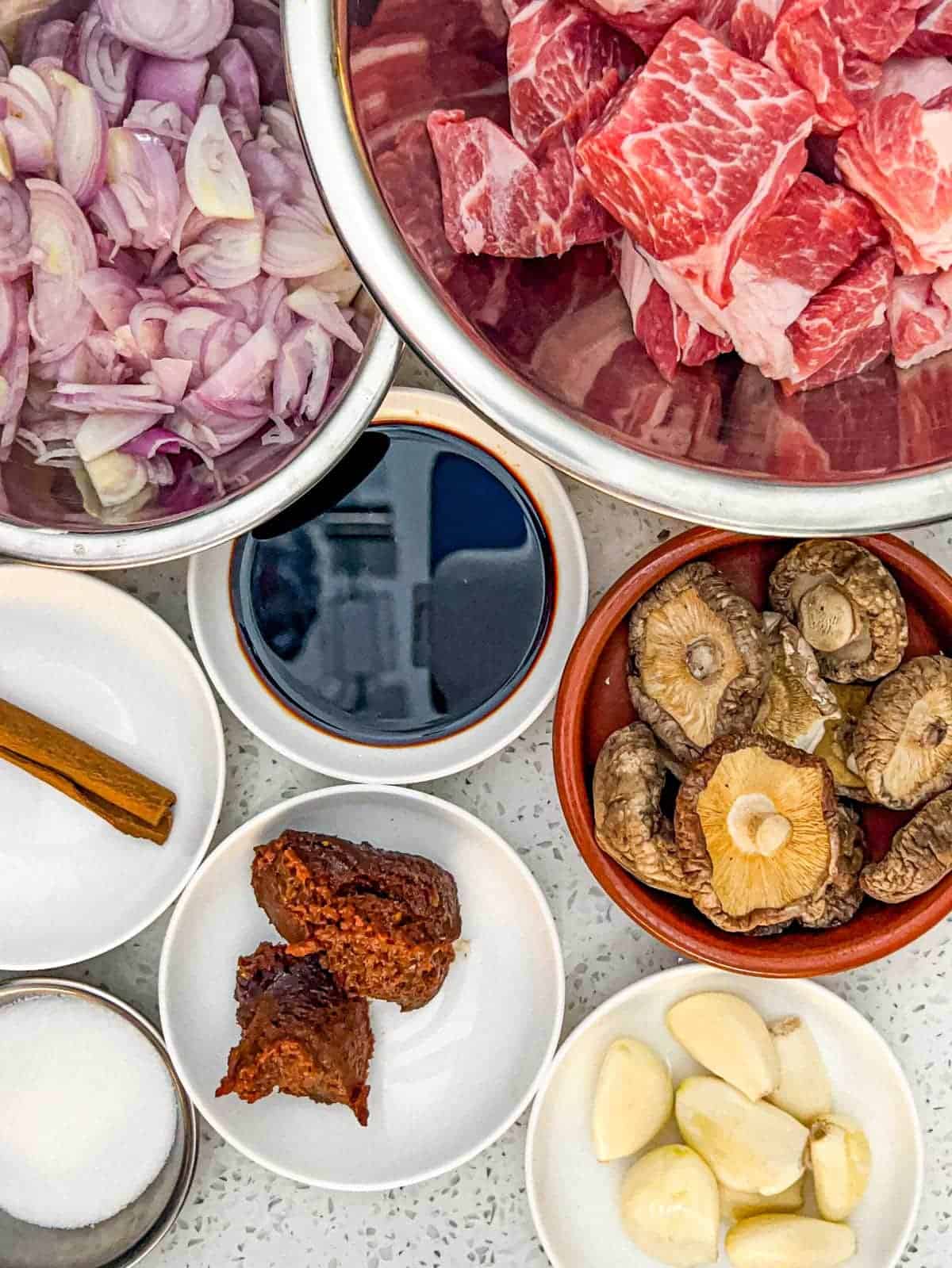 Ingredients for Babi Pongteh - Malaysian Pork stew: Pork, shallots, soy sauce, fermented bean paste, dried Chinese mushrooms, cinnamon and sugar