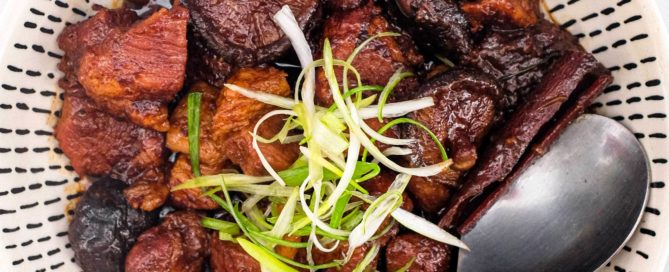Babi Pongteh (Malaysian Pork Stew) in a bowl with a spoon