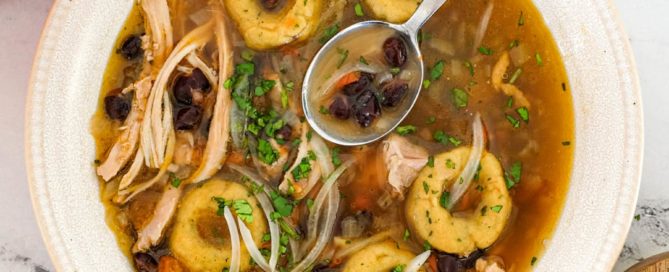 A bowl of chicken soup with Mexican dumplings called chochoyotes.