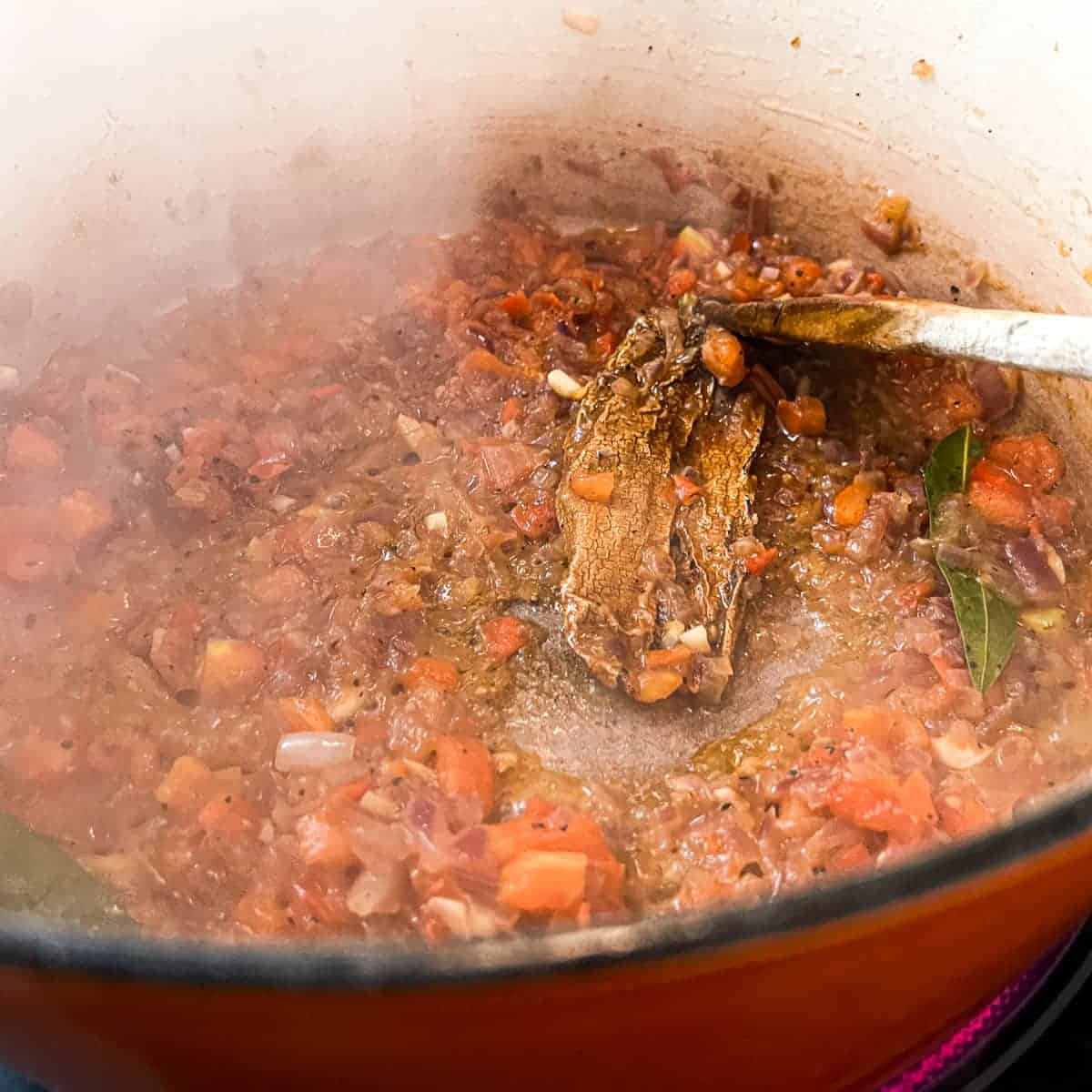 Frying the onion, tomato and chipotle pepper for Mexican chicken soup