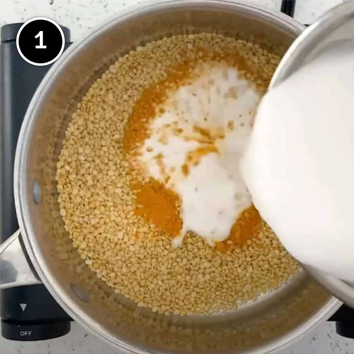 Coconut milk and turmeric are poured into moong dal for Parippu Curry