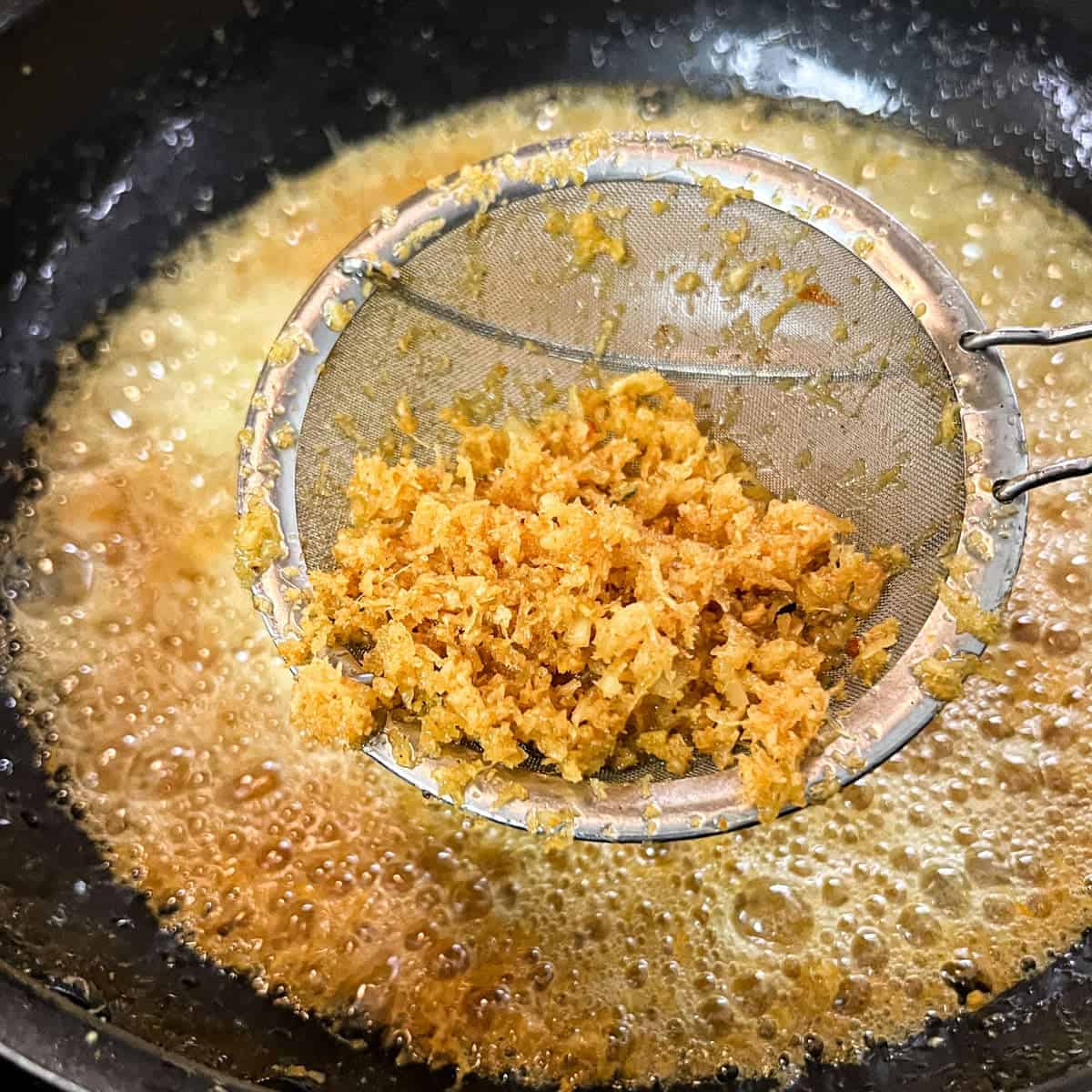 Making the crispy coconut serundeng