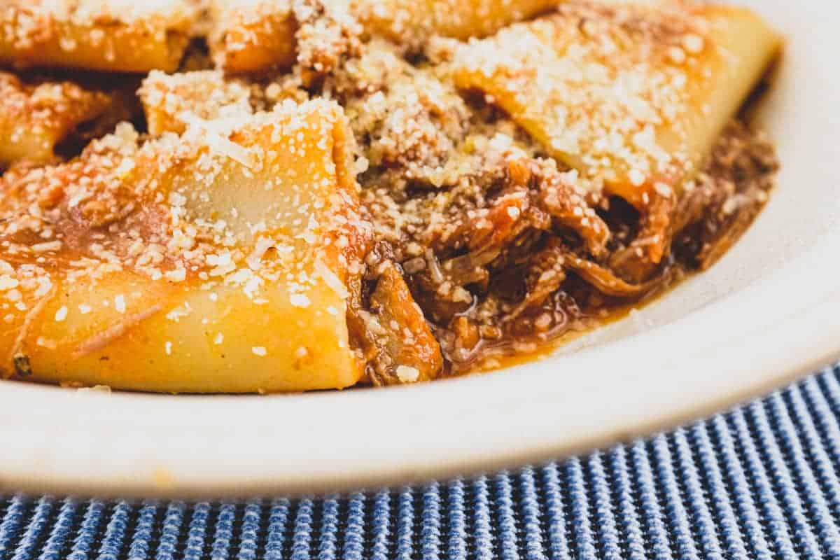 A bowl of paccheri pasta with a rich Neapolitan rag&ugrave; sauce