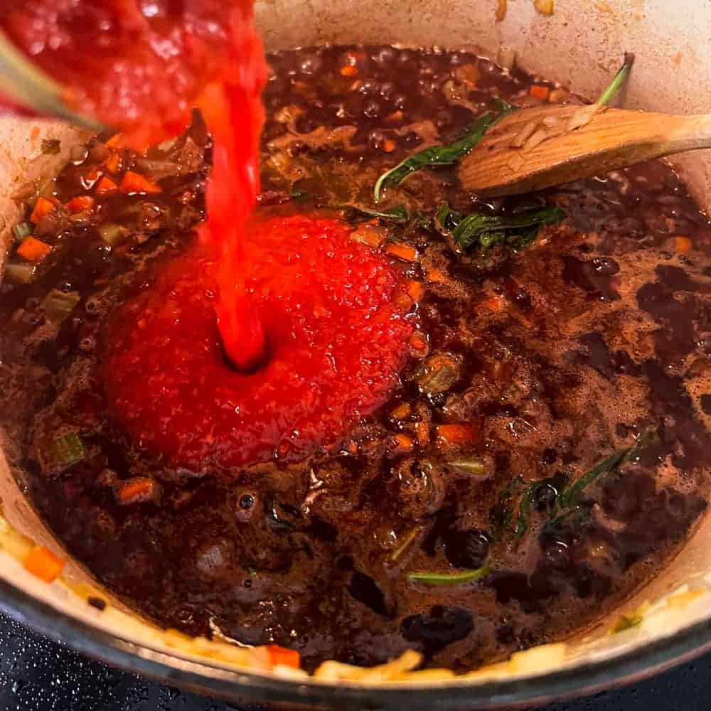 Adding red wine and tomato for the Neapolitan Ragù