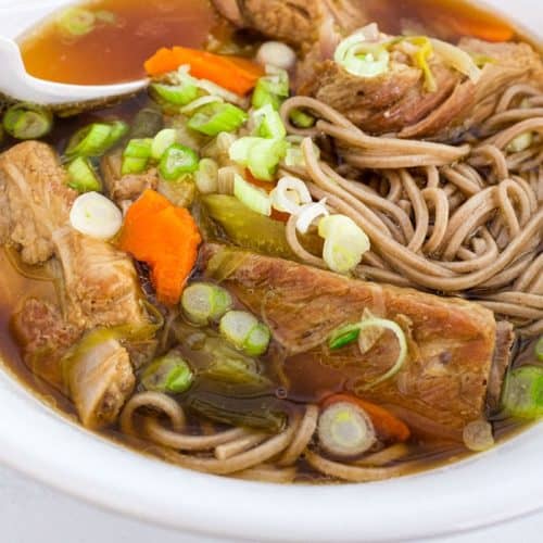 A bowl of pork rib soup with soba noodles