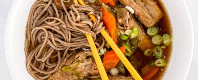 A bowl of pork rib soup with soba noodles