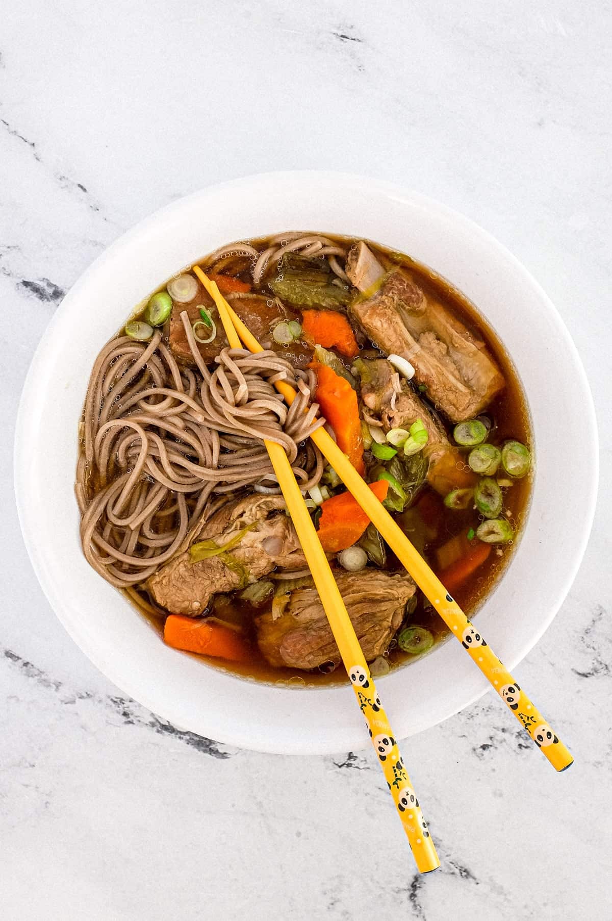 A bowl of pork rib soup with soba noodles