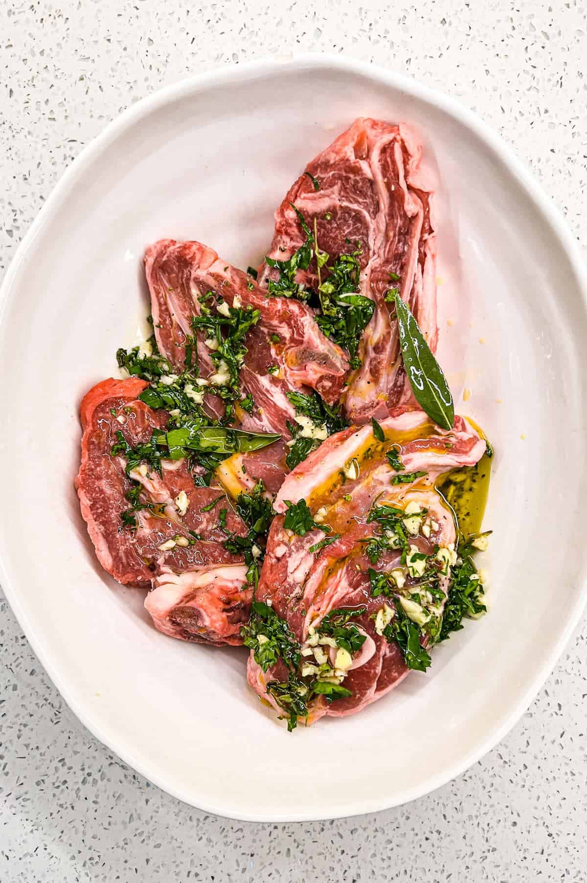 A combination of oil, lemon, garlic and fresh herbs create a simple marinade for Greek style lamb.