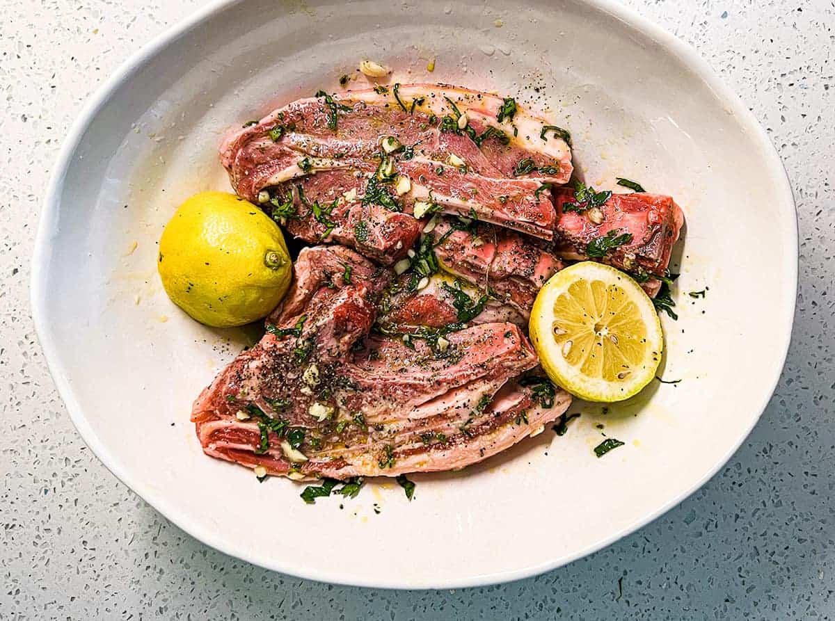 A combination of oil, lemon, garlic and fresh herbs create a simple marinade for Greek style lamb.