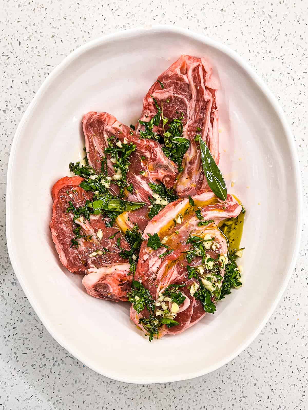 A combination of oil, lemon, garlic and fresh herbs create a simple marinade for Greek style lamb.